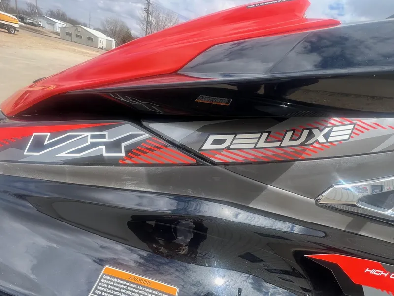 Slide: The Image of 2017 Yamaha WaveRunner VX Deluxe with red and black design, parked outdoors. - 4