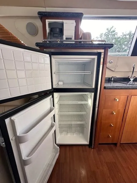 Slide: The Image of Open fridge door in Carver 450 Voyager Pilothouse yacht kitchen. - 29