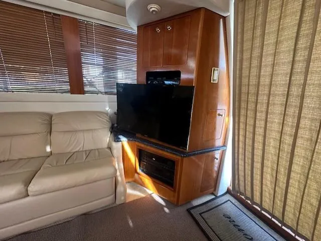 Slide: The Image of Interior of 2000 Carver 450 Voyager Pilothouse with sofa and TV. - 32