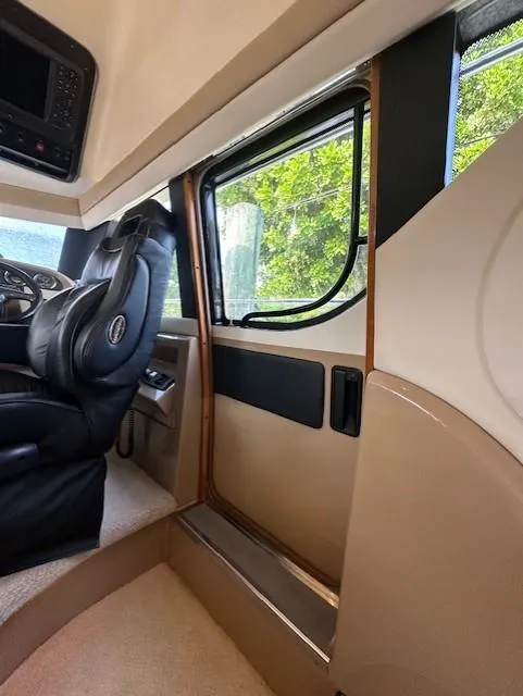 Slide: The Image of Interior of 2000 Carver 450 Voyager Pilothouse with leather seat and window. - 44