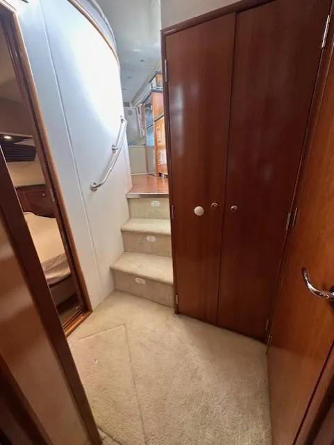 Slide: The Image of Interior of 2000 Carver 450 Voyager Pilothouse with stairs and wooden cabinets. - 49