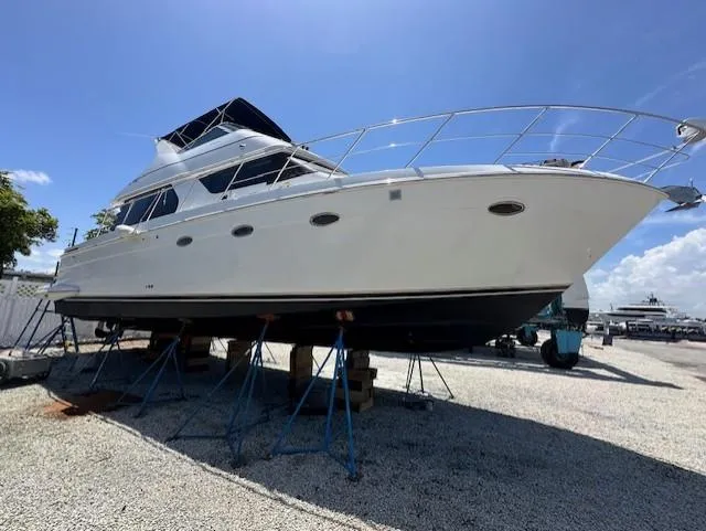 Slide: The Image of 2000 Carver 450 Voyager Pilothouse yacht on stands outdoors. - 7
