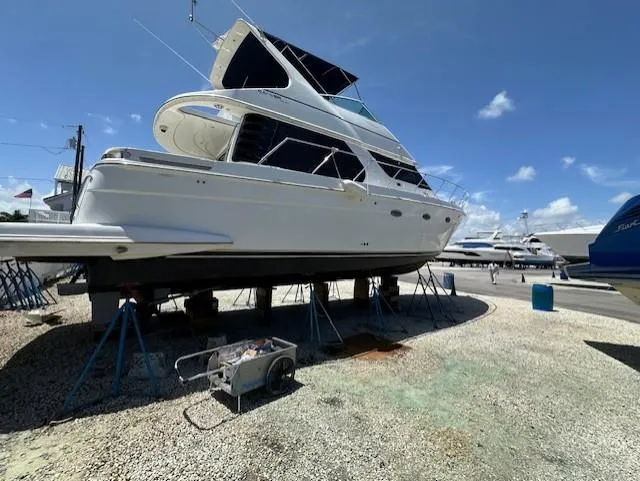 Slide: The Image of 2000 Carver 450 Voyager Pilothouse yacht docked at marina. - 8