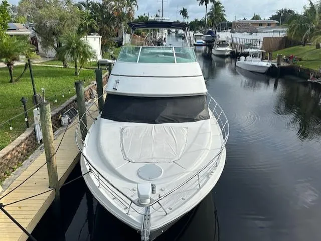 Slide: The Image of 2000 Carver 450 Voyager Pilothouse in a serene canal. - 9