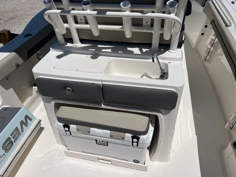 Slide: The Image of 2025 Key West 260 Center Console boat interior with sink and storage area. - 15