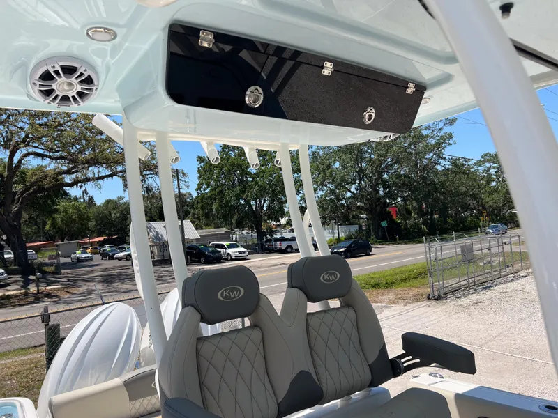Slide: The Image of 2025 Key West 260 Center Console boat interior with seating and overhead storage. - 18