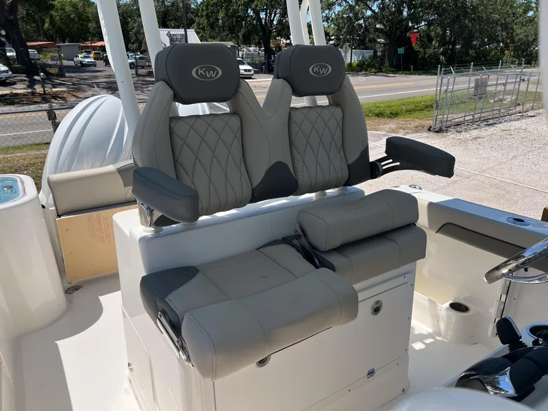 Slide: The Image of 2025 Key West 260 Center Console boat with dual cushioned seats and armrests. - 19