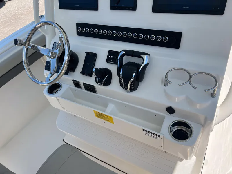 Slide: The Image of 2025 Key West 260 Center Console boat dashboard with steering wheel and controls. - 20