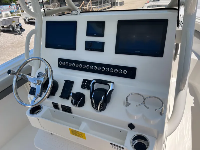 Slide: The Image of Control panel of 2025 Key West 260 Center Console boat with modern navigation displays. - 21