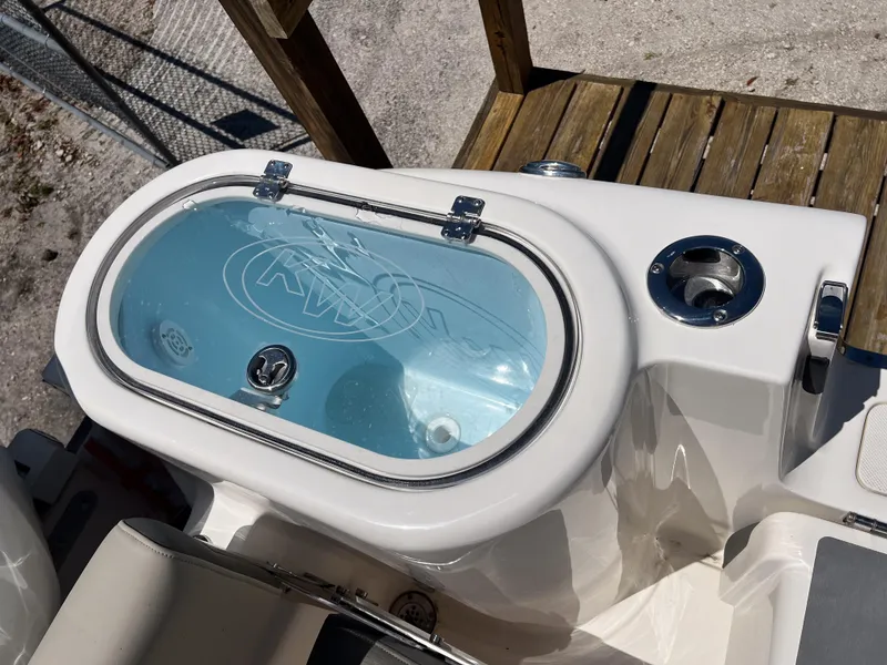 Slide: The Image of Livewell on 2025 Key West 260 Center Console boat, featuring a clear lid and sleek design. - 24