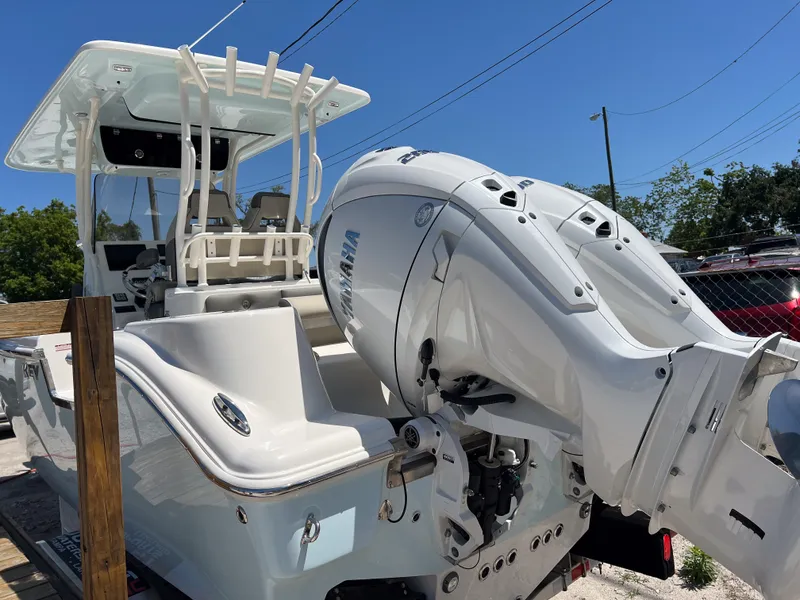 Slide: The Image of 2025 Key West 260 Center Console boat with Yamaha outboard motor, docked under clear blue sky. - 3