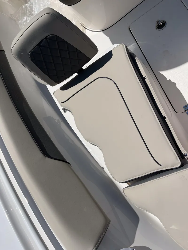 Slide: The Image of 2025 Key West 260 Center Console boat interior with cushioned seating and storage. - 34