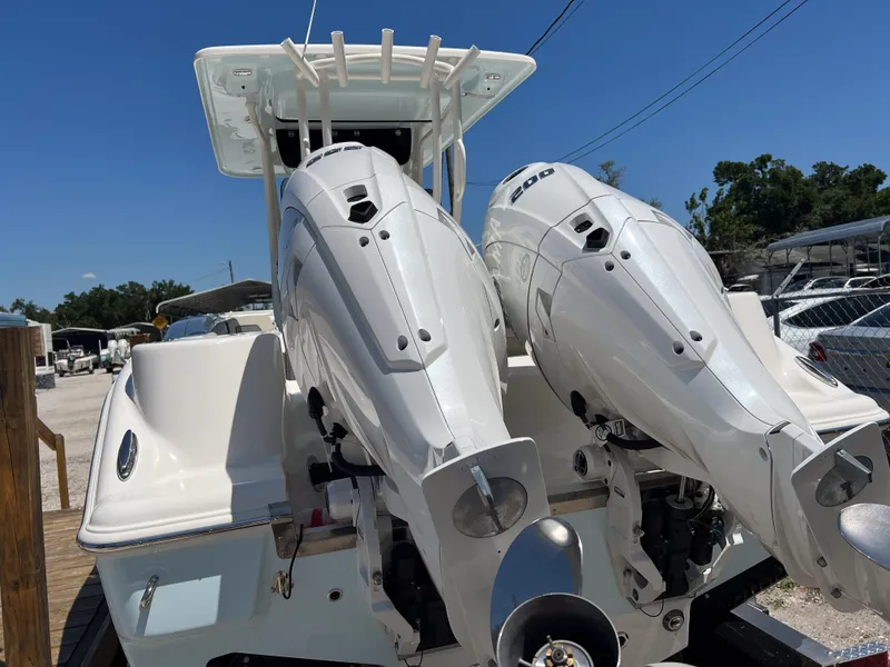 Slide: The Image of 2025 Key West 260 Center Console with dual outboard engines, docked under clear blue sky. - 4