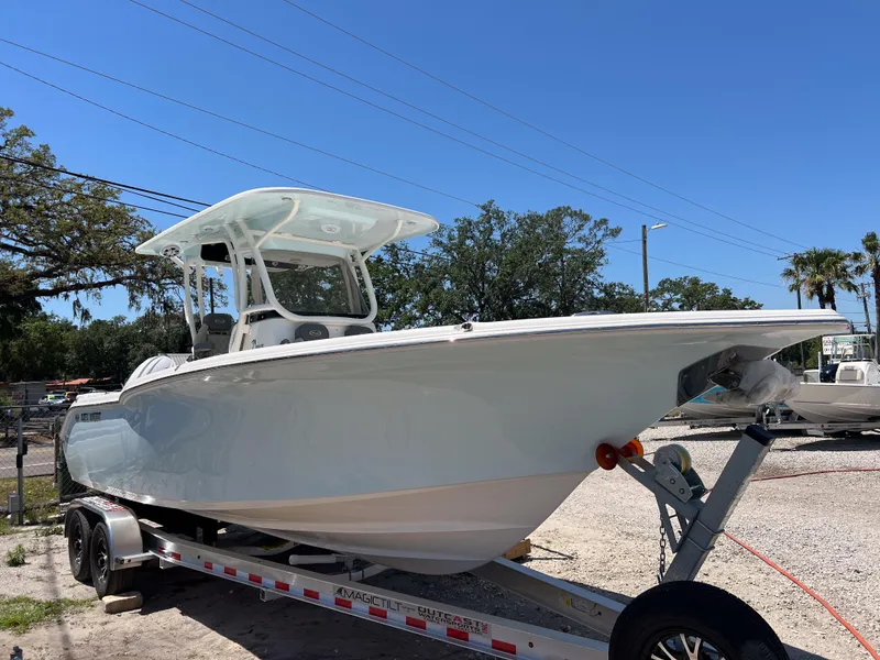 Slide: The Image of 2025 Key West 260 Center Console boat on trailer under clear blue sky. - 6