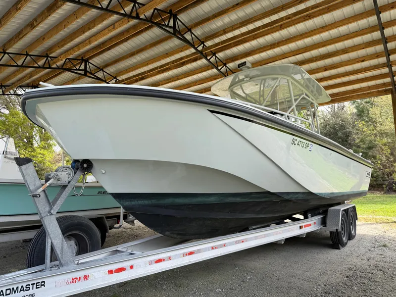 The Image of 2004 Boston Whaler Guardian 27 on trailer under shelter. - 0