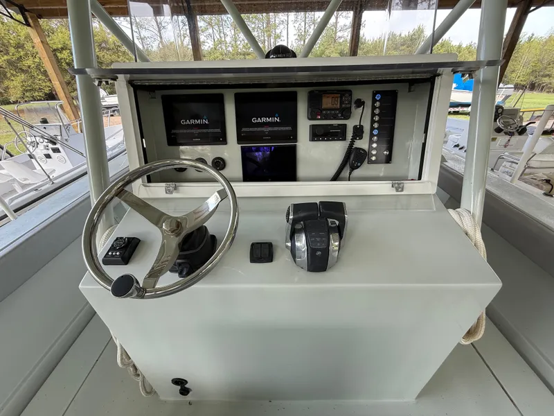 Slide: The Image of Boston Whaler Guardian 27 helm with Garmin displays and controls, 2004 model. - 15