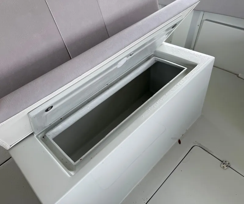 Slide: The Image of Open storage compartment on a 2004 Boston Whaler Guardian 27 boat. - 28