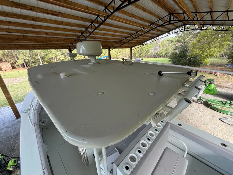 Slide: The Image of 2004 Boston Whaler Guardian 27 under a covered structure, showcasing its deck and equipment. - 31