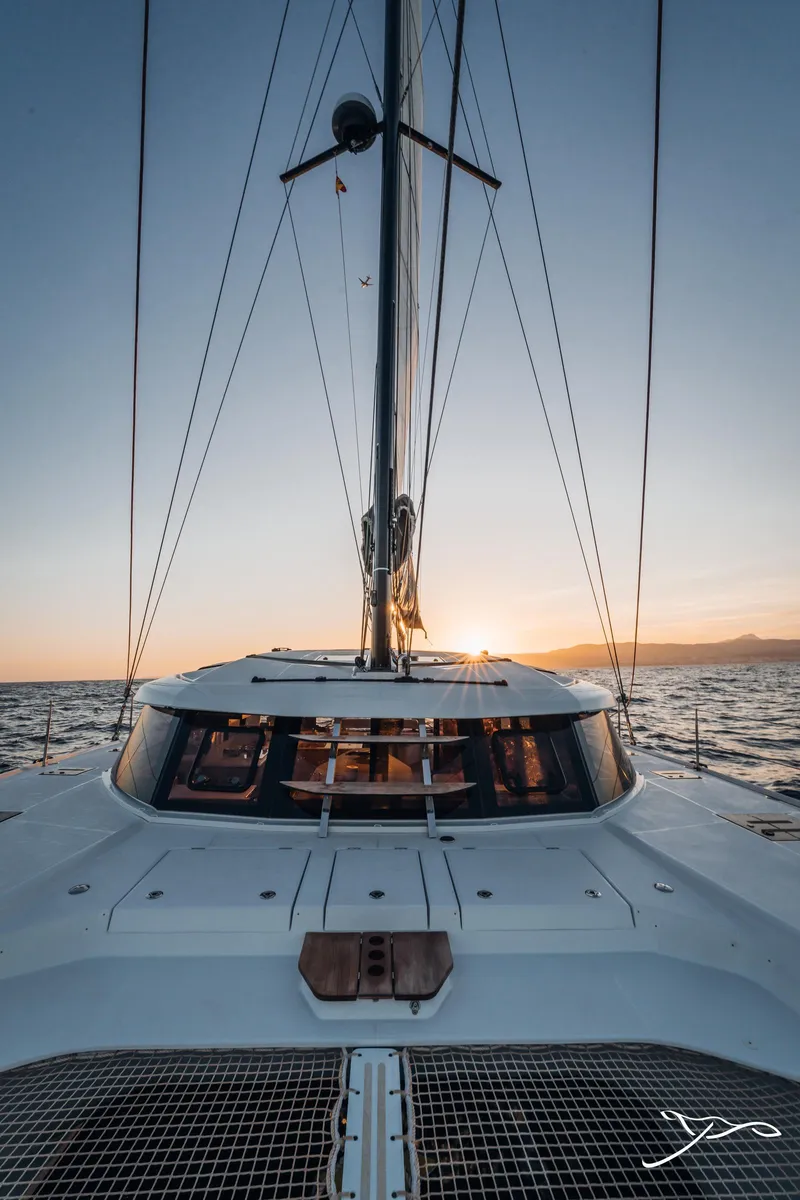 Slide: The Image of 2025 Nautitech 44 Open sailing at sunset, showcasing sleek design and ocean view. - 10