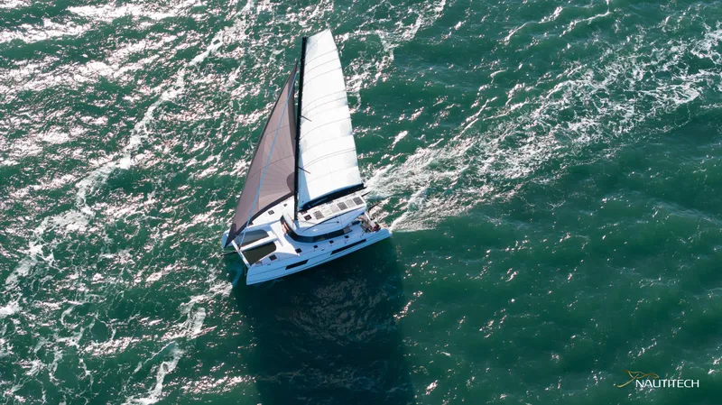 Slide: The Image of Aerial view of 2025 Nautitech 48 Open sailing on open sea. - 9
