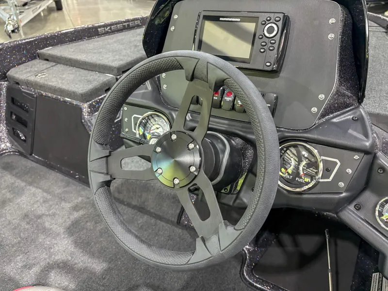 Slide: The Image of Steering console of 2025 Skeeter ZX150 boat with modern controls and display. - 10