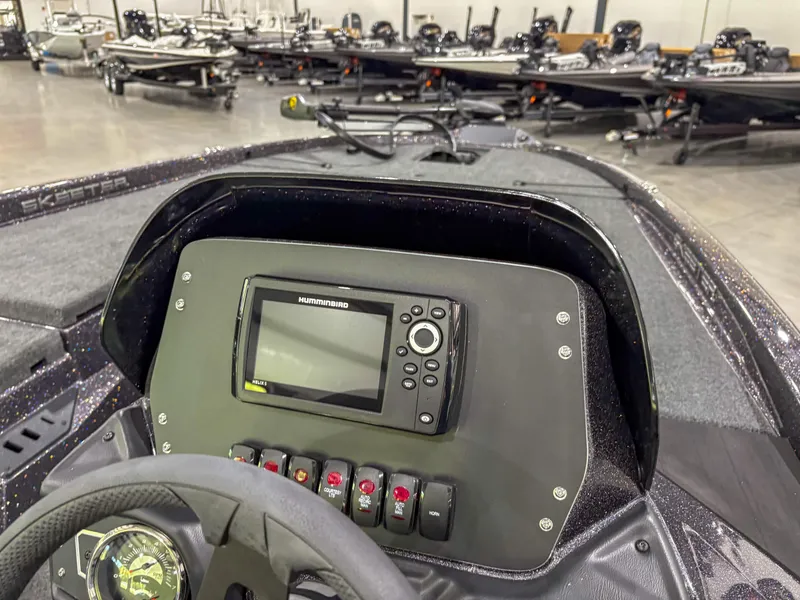 Slide: The Image of 2025 Skeeter ZX150 boat dashboard with Humminbird fishfinder in showroom. - 11