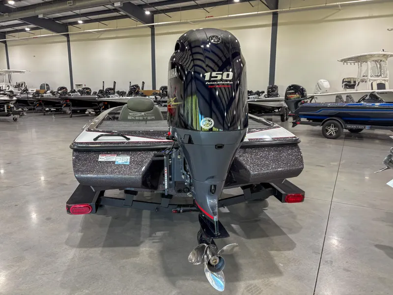 Slide: The Image of 2025 Skeeter ZX150 boat with powerful outboard motor in a showroom. - 3