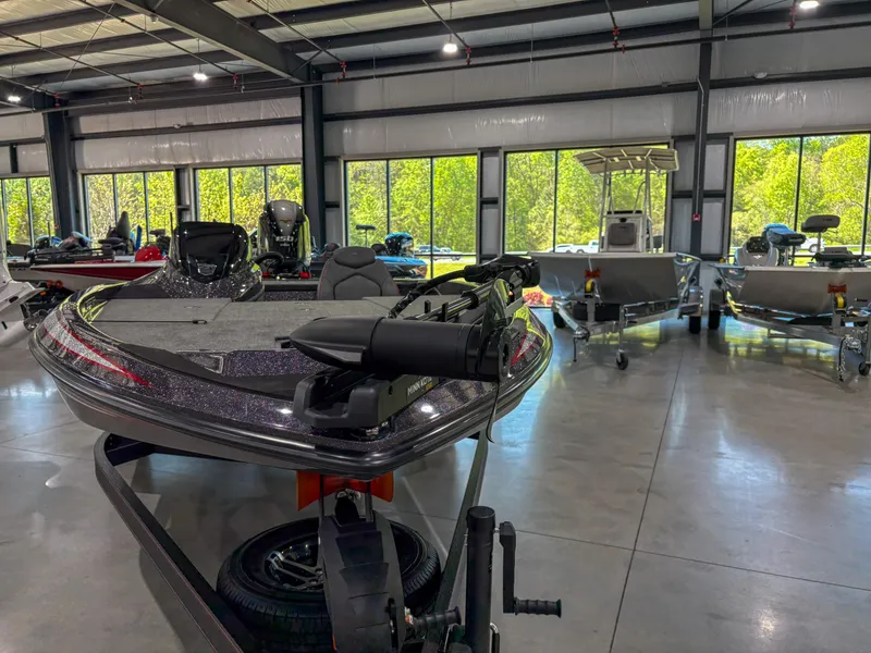Slide: The Image of 2025 Skeeter ZX150 boat displayed in a showroom with large windows. - 4