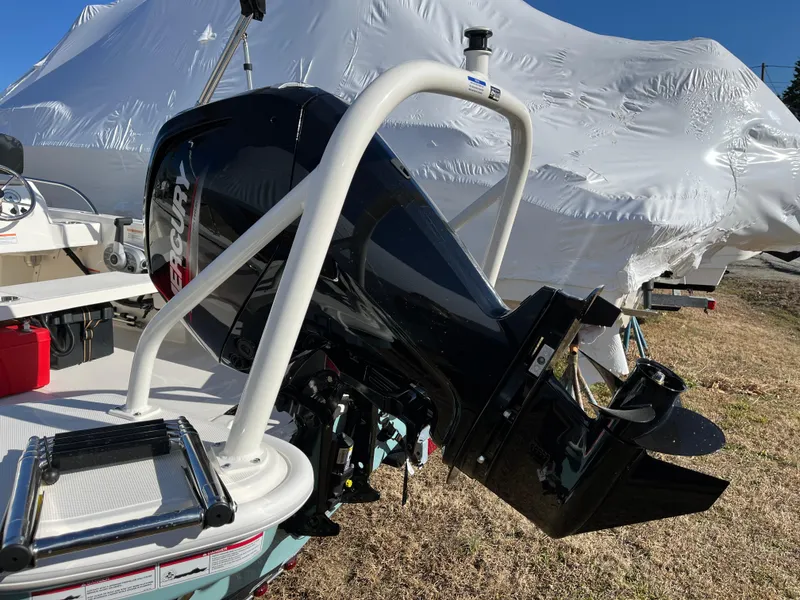 Slide: The Image of 2025 Boston Whaler 160 Super Sport with Mercury outboard motor, parked outdoors. - 14