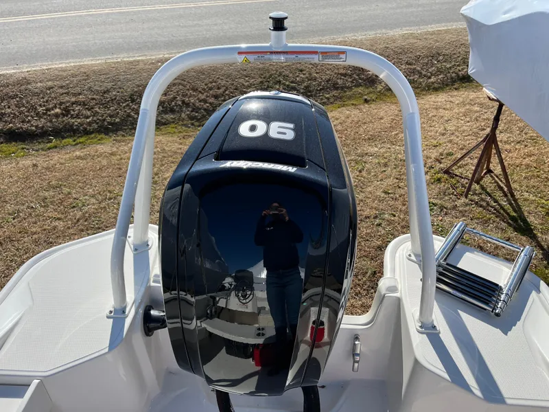 Slide: The Image of 2025 Boston Whaler 160 Super Sport with 90 HP engine, rear view on display. - 17