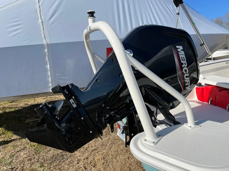 Slide: The Image of 2025 Boston Whaler 160 Super Sport with Mercury outboard motor, parked outdoors. - 2