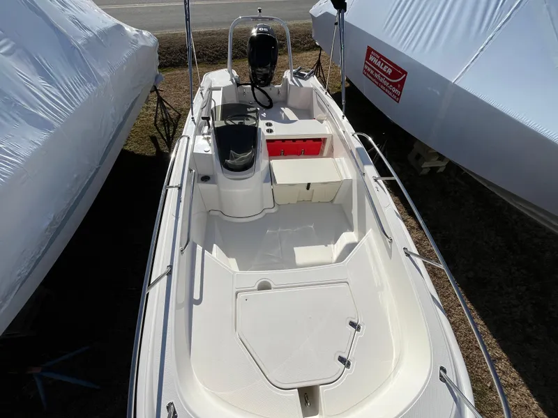 Slide: The Image of 2025 Boston Whaler 160 Super Sport boat, top view, docked, with white interior and console. - 4
