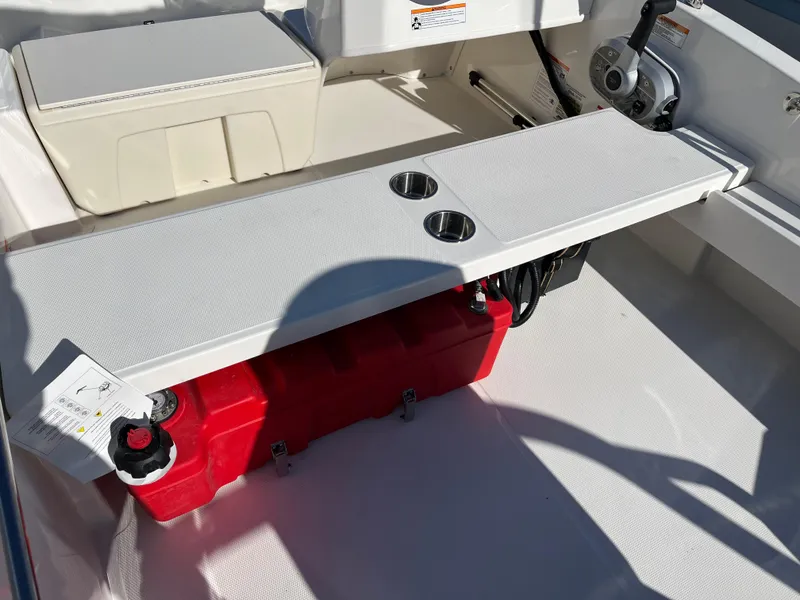 Slide: The Image of 2025 Boston Whaler 160 Super Sport interior with bench seat and red fuel tank. - 7
