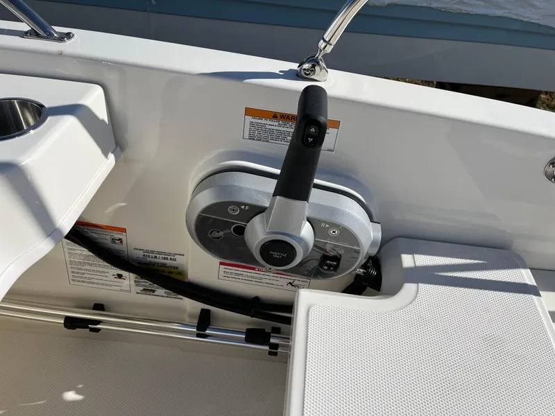 Slide: The Image of 2025 Boston Whaler 160 Super Sport boat control panel with throttle lever. - 8