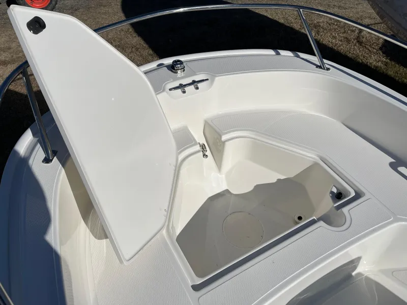 Slide: The Image of 2025 Boston Whaler 160 Super Sport boat with open storage compartment. - 9
