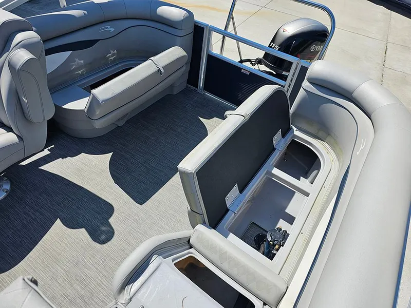 Slide: The Image of 2021 Bennington 20 SSR pontoon boat interior with open storage compartments and seating. - 12