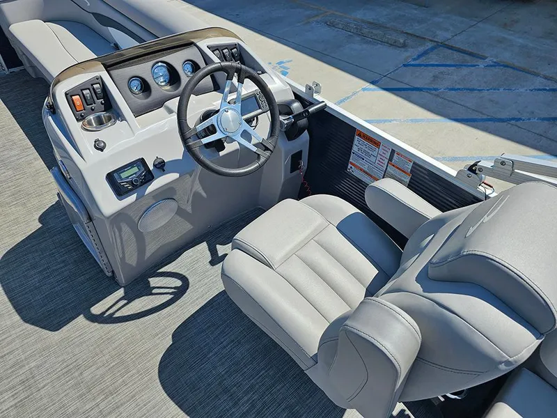 Slide: The Image of 2021 Bennington 20 SSR boat interior with steering wheel and comfortable seating. - 13
