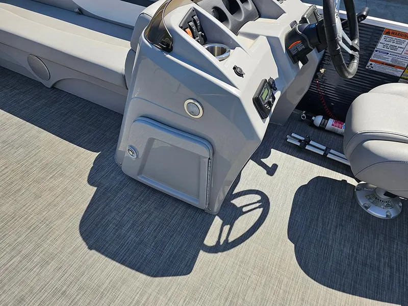 Slide: The Image of Interior of a 2021 Bennington 20 SSR boat, featuring steering console and seating. - 15
