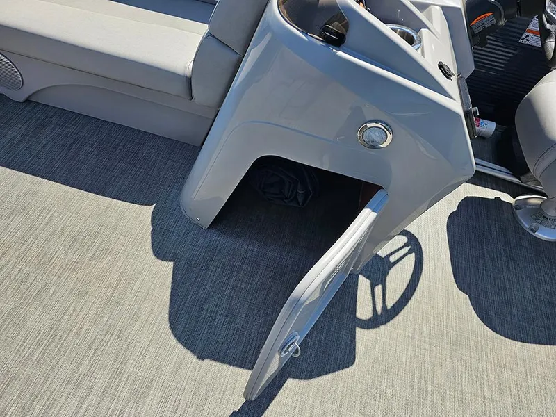 Slide: The Image of 2021 Bennington 20 SSR boat interior with open storage compartment and seating area. - 16