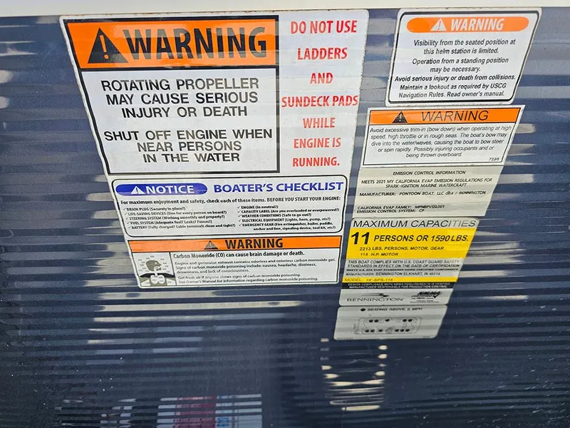 Slide: The Image of Warning labels on a 2021 Bennington 20 SSR boat, highlighting safety precautions and capacity limits. - 20