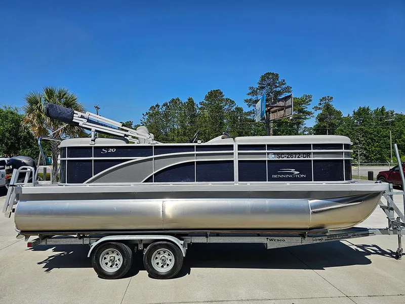 Slide: The Image of 2021 Bennington 20 SSR pontoon boat on trailer, parked outdoors. - 6