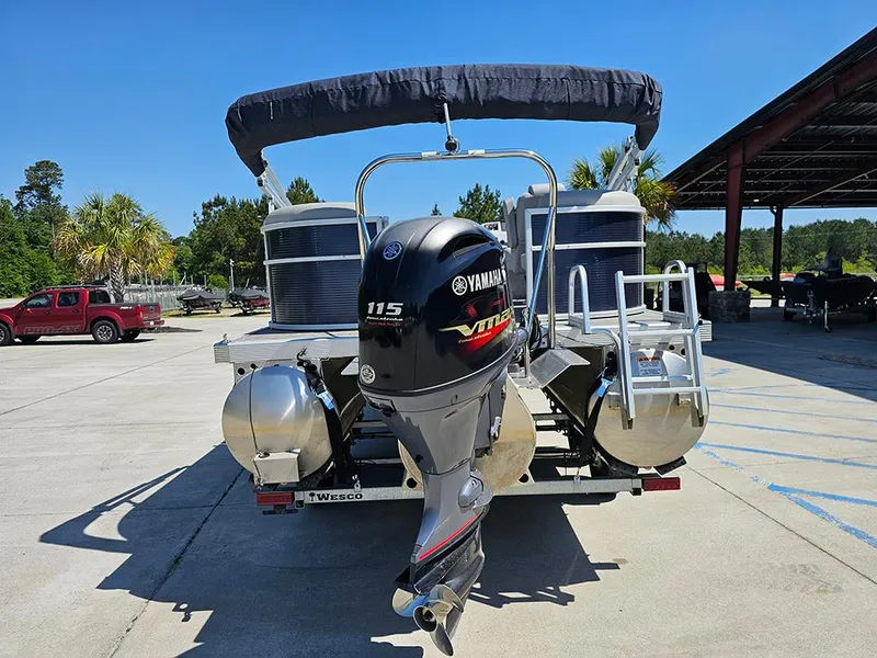 Slide: The Image of 2021 Bennington 20 SSR pontoon boat with Yamaha 115 engine, parked outdoors. - 8