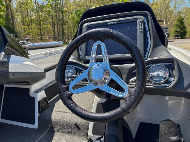 Slide: The Image of 2014 Skeeter FX 21 boat dashboard with steering wheel and navigation display. - 11