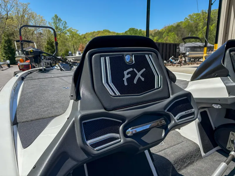 Slide: The Image of 2014 Skeeter FX 21 boat dashboard with FX logo, outdoors on a sunny day. - 13