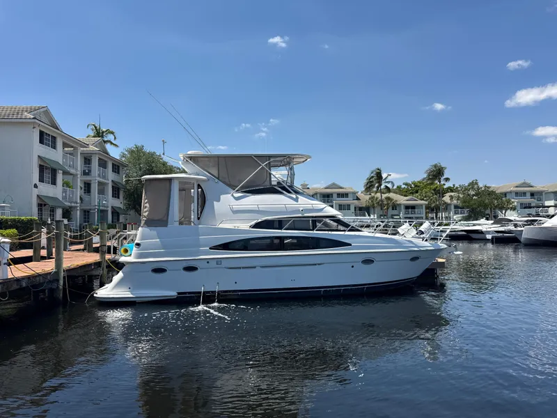 Slide: The Image of 2001 Carver 396 Motor Yacht docked at marina under clear blue sky. - 1