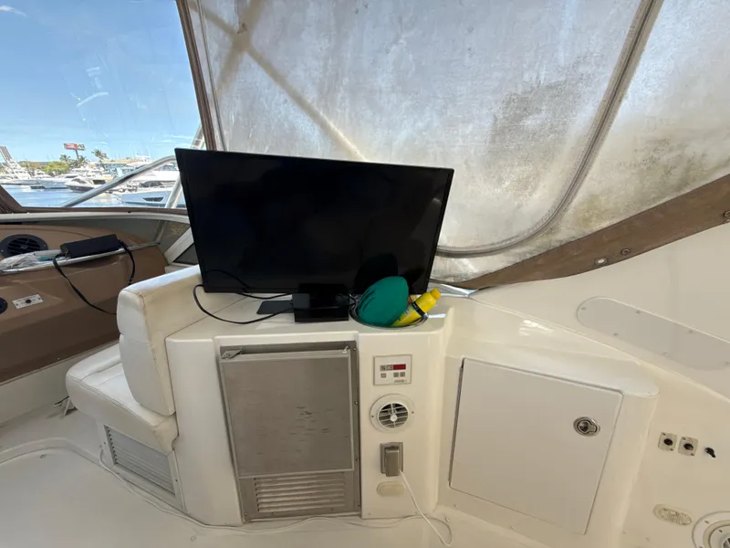 Slide: The Image of 2001 Carver 396 Motor Yacht interior with TV and storage compartments. - 12