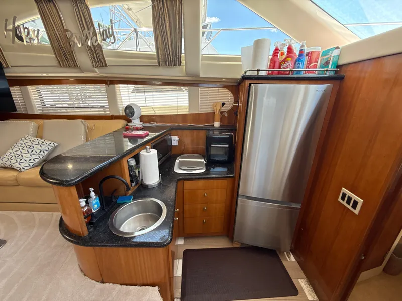 Slide: The Image of Interior of 2001 Carver 396 Motor Yacht with kitchenette and stainless steel appliances. - 16