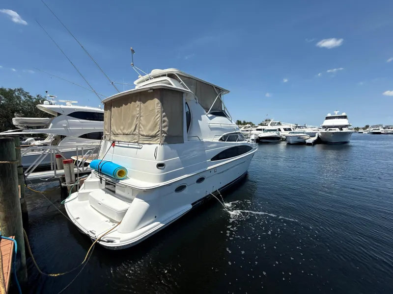 Slide: The Image of 2001 Carver 396 Motor Yacht docked in a marina under clear blue skies. - 2