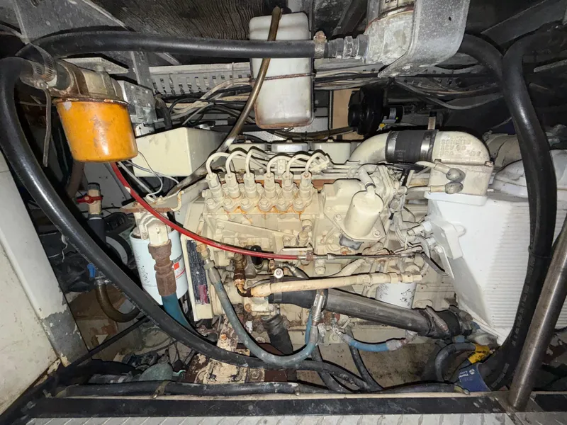 Slide: The Image of Engine compartment of a 2001 Carver 396 Motor Yacht, showcasing mechanical components and wiring. - 28