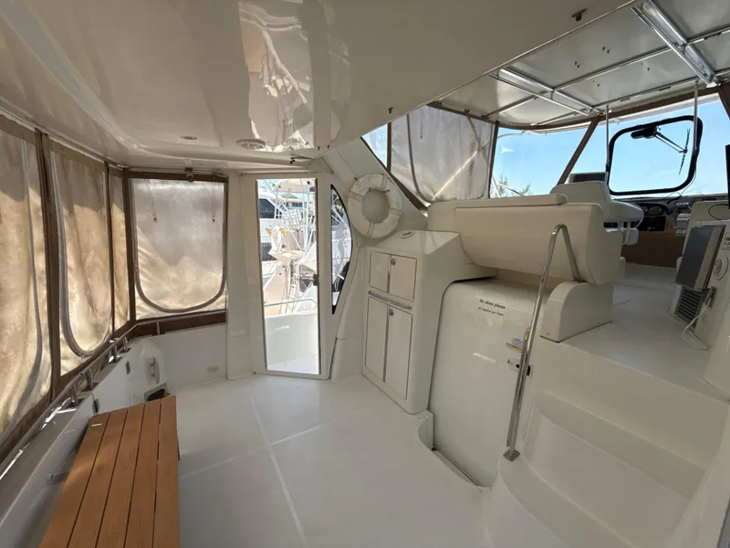 Slide: The Image of 2001 Carver 396 Motor Yacht interior with helm, seating, and panoramic windows. - 5